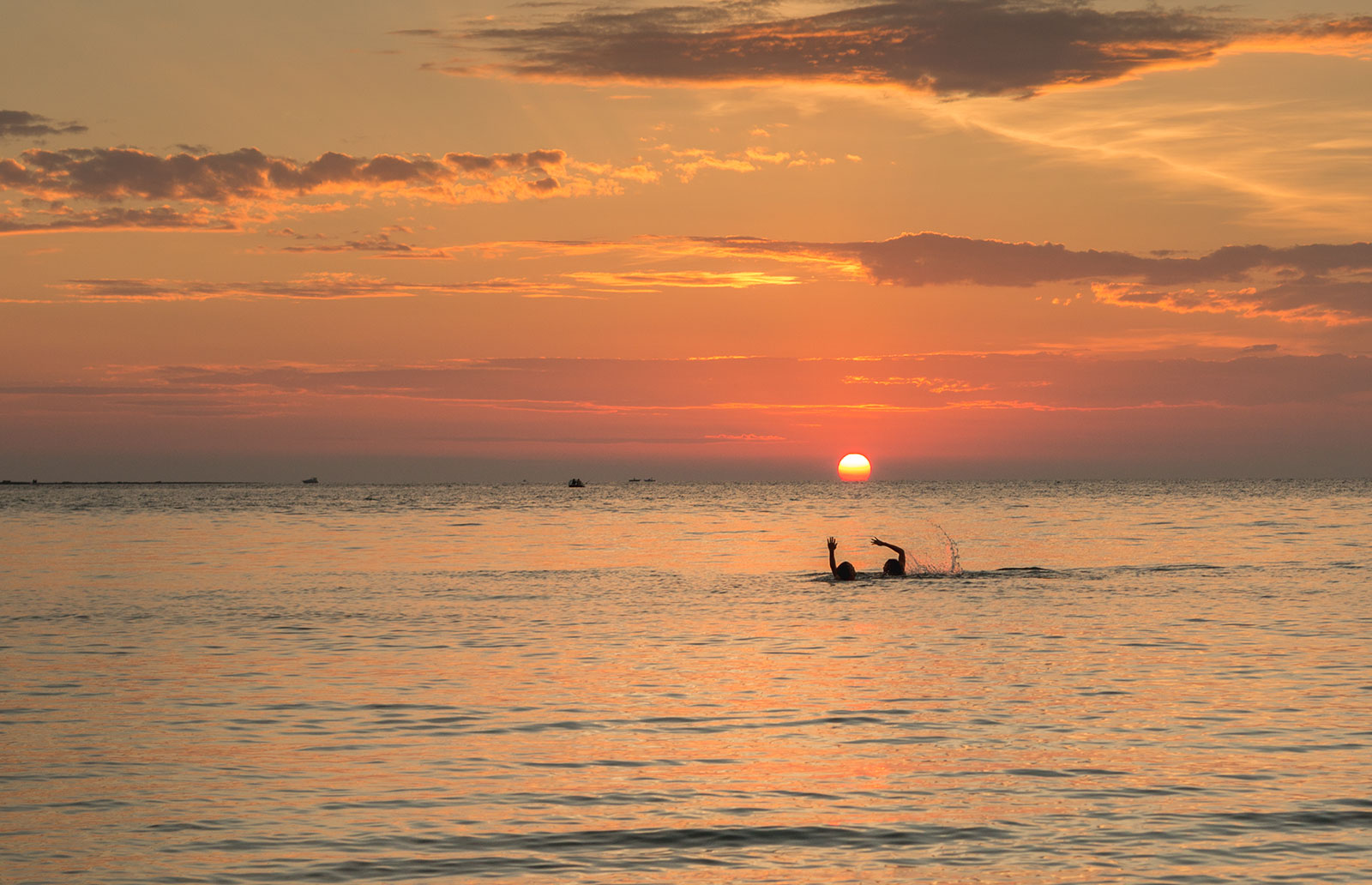 Gallipoli, Puglia. Sunset with happy swimmers
